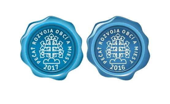 Dve modré pečate s nápisom Pečať rozvoja obcí a miest s rokmi 2017 a 2016 Dve modré pečate s nápisom Pečať rozvoja obcí a miest s rokmi 2017 a 2016